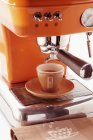 Cup of espresso on coffee machine — Stock Photo