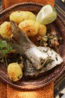 Sea bass with roast potatoes — Stock Photo