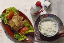 Closeup view of deep-fried chicken with salad and boiled rice — Stock Photo