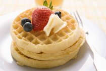 Waffles with butter and berries — Stock Photo