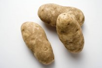Drei rohe Kartoffeln — Stockfoto