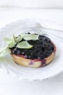 Bilberry tartlets on plate — Stock Photo