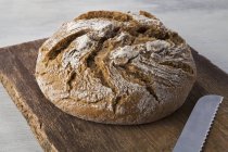 Country bread on board — Stock Photo