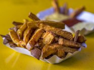 Potato fries with mustard — Stock Photo