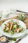 Closeup view of Satay skewers with coriander and limes — Stock Photo