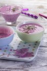 Chlodnik - cold beetroot soup in colored bowls on tray with spoon — Stock Photo
