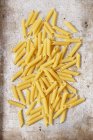 Uncooked penne rigate pasta — Stock Photo
