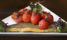 Fried seabass with tomatoes — Stock Photo
