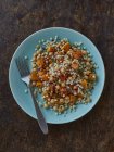 Couscous salad with squash and chilli flakes — Stock Photo