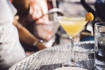 Cocktail in glass over table — Stock Photo