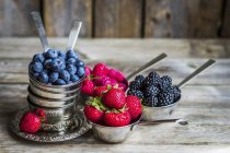 Fresh berries in silver cups — Stock Photo