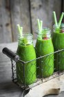 Green smoothies and bottles — Stock Photo