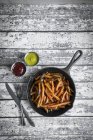Sweet potato fries in iron pan — Stock Photo
