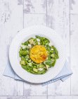 Baked eggs on salad — Stock Photo