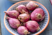 Red onions in bowl — Stock Photo