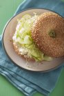 Bagel filled with cucumber — Stock Photo