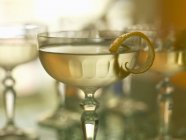Cocktail with lemon peel — Stock Photo