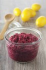 A jar of beetroot hummus over wooden surface — Stock Photo