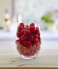 Fresh raspberries in a glass — Stock Photo