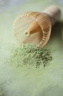 Closeup view of Matcha tea powder heap and a whisk — Stock Photo