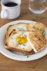 Closeup view of a fried eggs on toasts — Stock Photo