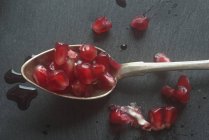 Spoon with pomegranate seeds — Stock Photo