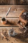 Elevated view of aromatic coffee beans and old coffee grinder — Stock Photo