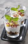 Closeup view of mango and pomegranate Trifles in glasses — Stock Photo