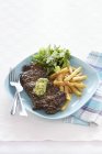 Steak with herbal butter and salad — Stock Photo