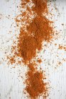Top view of chilli powder on a white wooden surface — Stock Photo