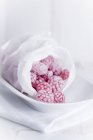 Raspberry sweets in bag — Stock Photo