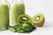 Green smoothies with spinach in glass — Stock Photo