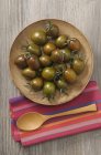 Black tomatoes on plate — Stock Photo