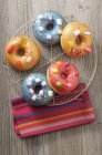 Doughnuts with colored sugar glaze — Stock Photo