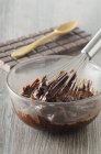 Melted chocolate with whisk — Stock Photo