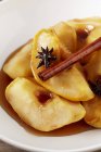 Closeup view of poached quinces with cinnamon and star anise — Stock Photo