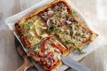 Square pizza with toppings — Stock Photo