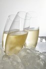 Closeup view of glasses of Prosecco surrounded by ice cubes — Stock Photo
