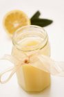 Closeup view of lemon curd in jar with a chiffon ribbon — Stock Photo