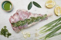 Raw leg of lamb with ingredients — Stock Photo