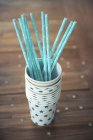 Closeup view of blue straws in a stack of paper cups decorated with stars — Stock Photo