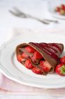 Chocolate crepe with raspberries — Stock Photo
