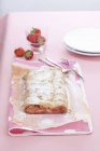 Closeup view of strawberry strudel with icing sugar — Stock Photo
