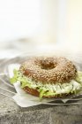 Bagel with lettuce and cheese — Stock Photo