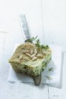 Closeup view of pistachio fish pie with pine nuts — Stock Photo