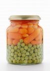 Peas and carrots in jar — Stock Photo