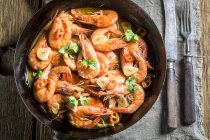 Prawns with garlic and chili peppers — Stock Photo