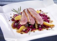 Duck breast on bed of red cabbage — Stock Photo