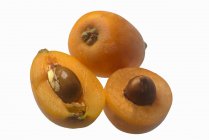 Fresh whole and halved Loquats — Stock Photo