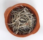 Top view of glass eels in a terracotta bowl — Stock Photo